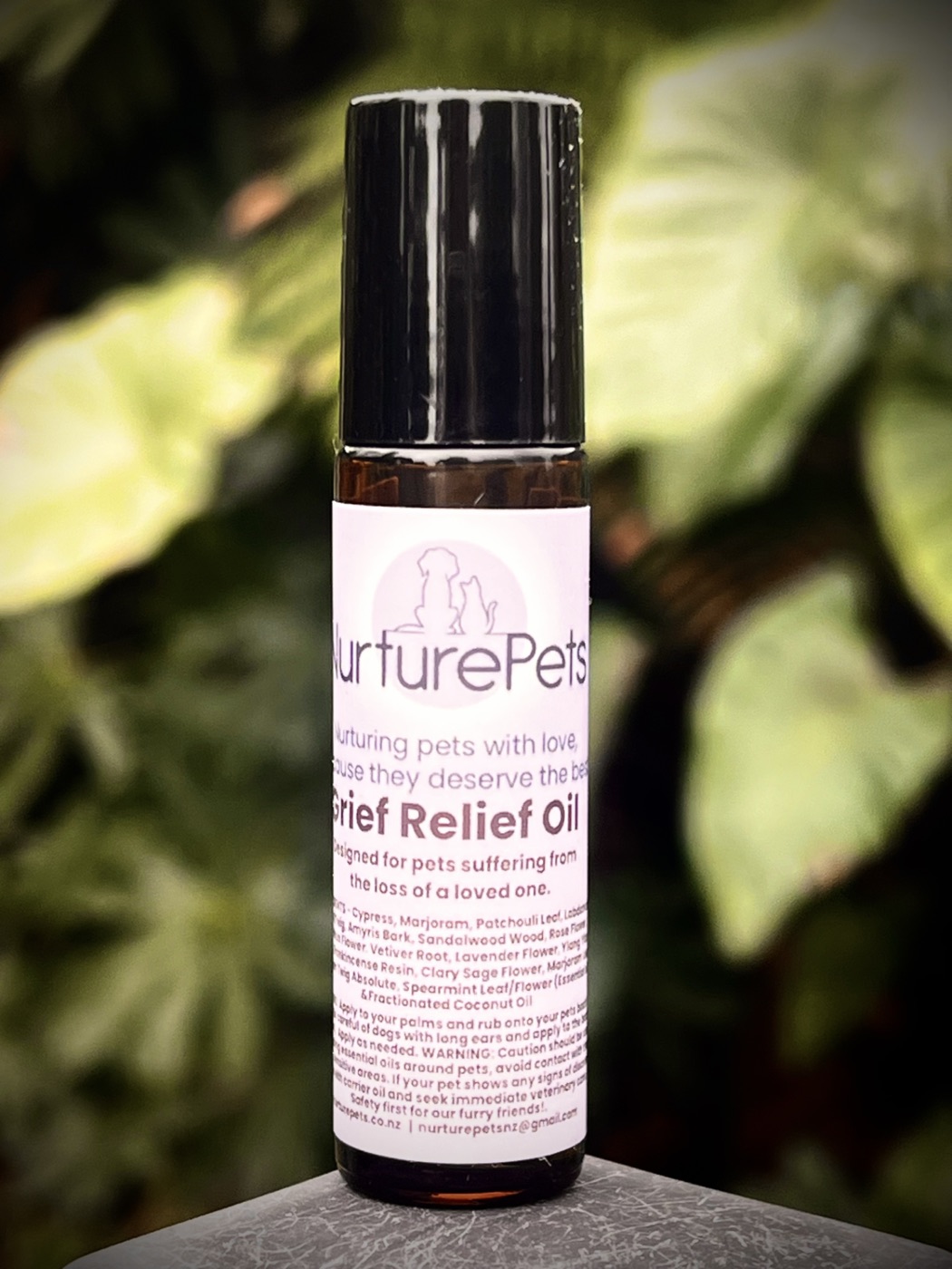 Nurture Pets Grief Relief essential oil roller on foliage